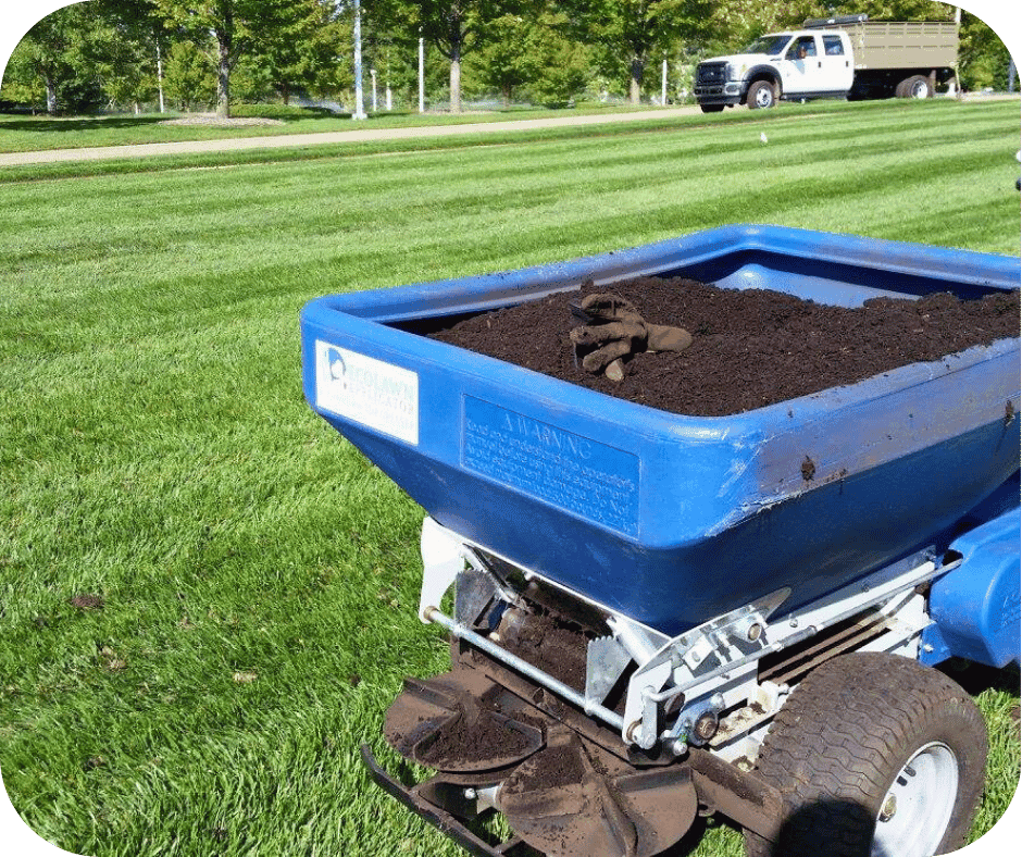 Compost topdressing being applied to a lawn